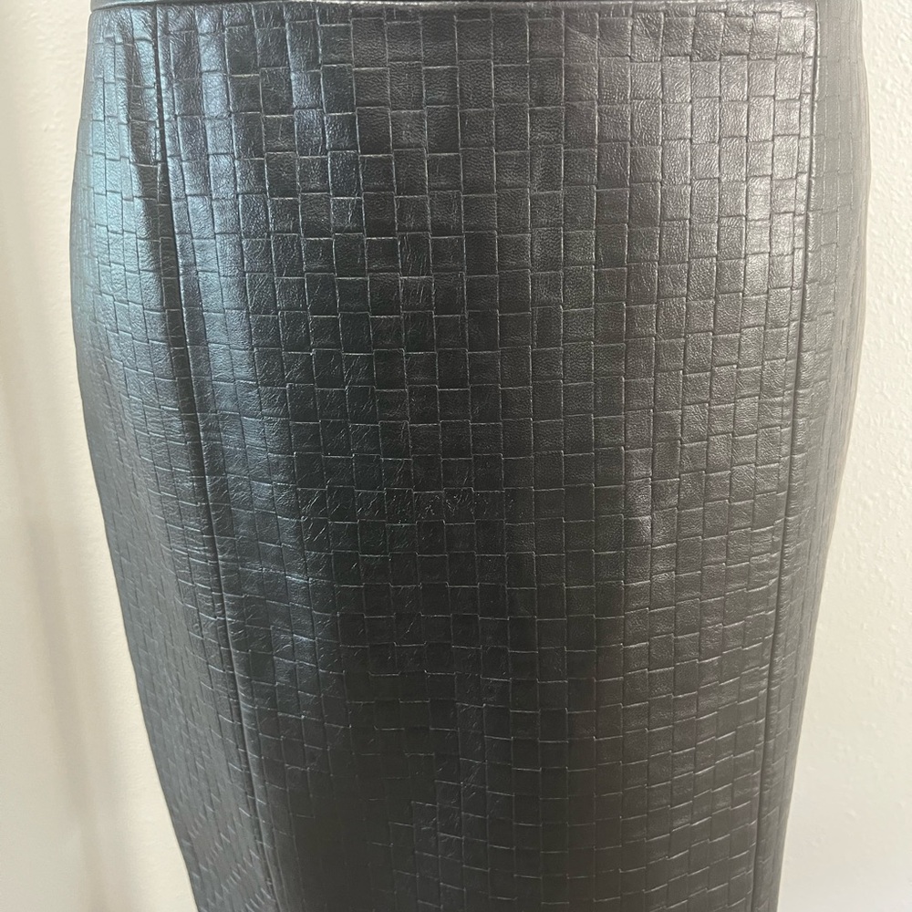 Black leather skirt, size 4, back zipper, 20” long.